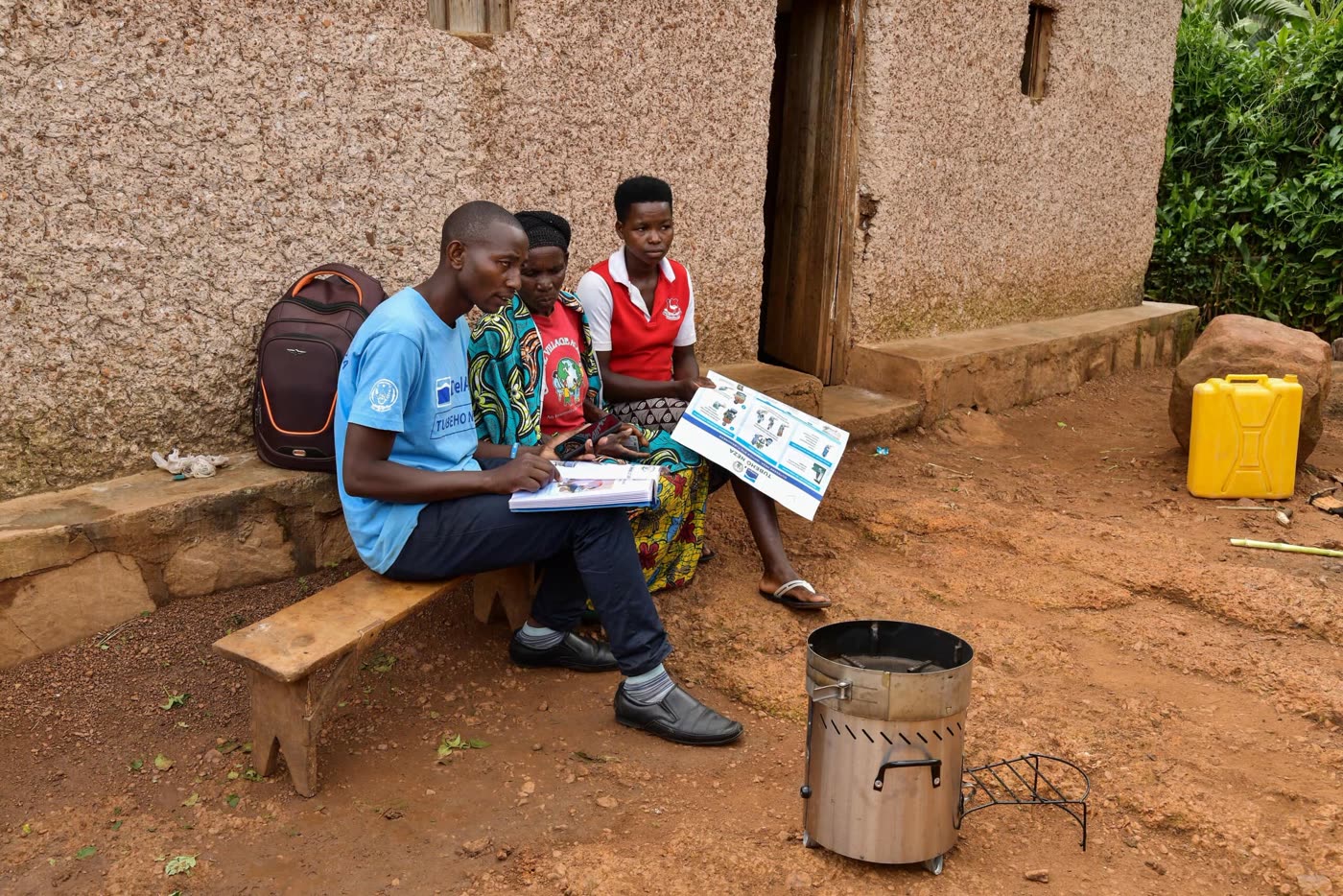 Community health workers instructing a family on stove use